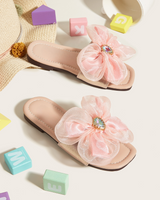 Big flower adorned pink slippers